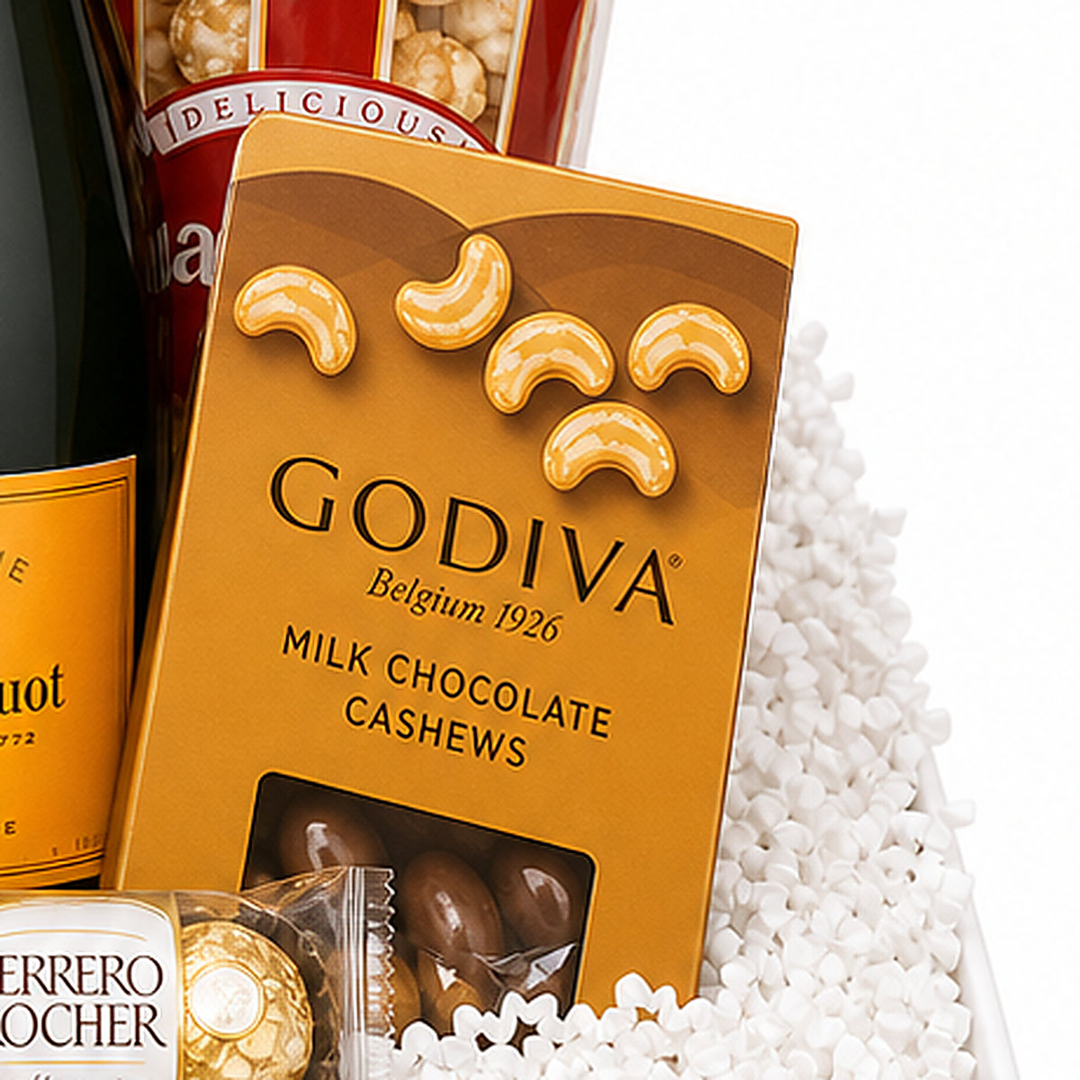 Close-up of the Godiva milk chocolate cashews included in the Luxury Champagne Gift Basket.