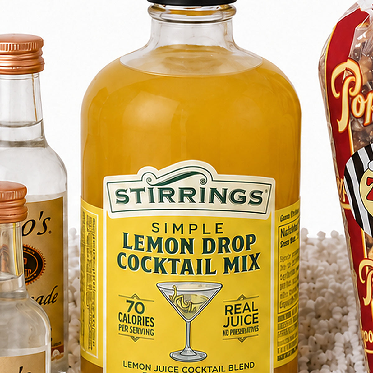 Close-up of the Stirrings Simple Lemon Drop cocktail mix bottle included in the Lemon Drop Martini gift set.