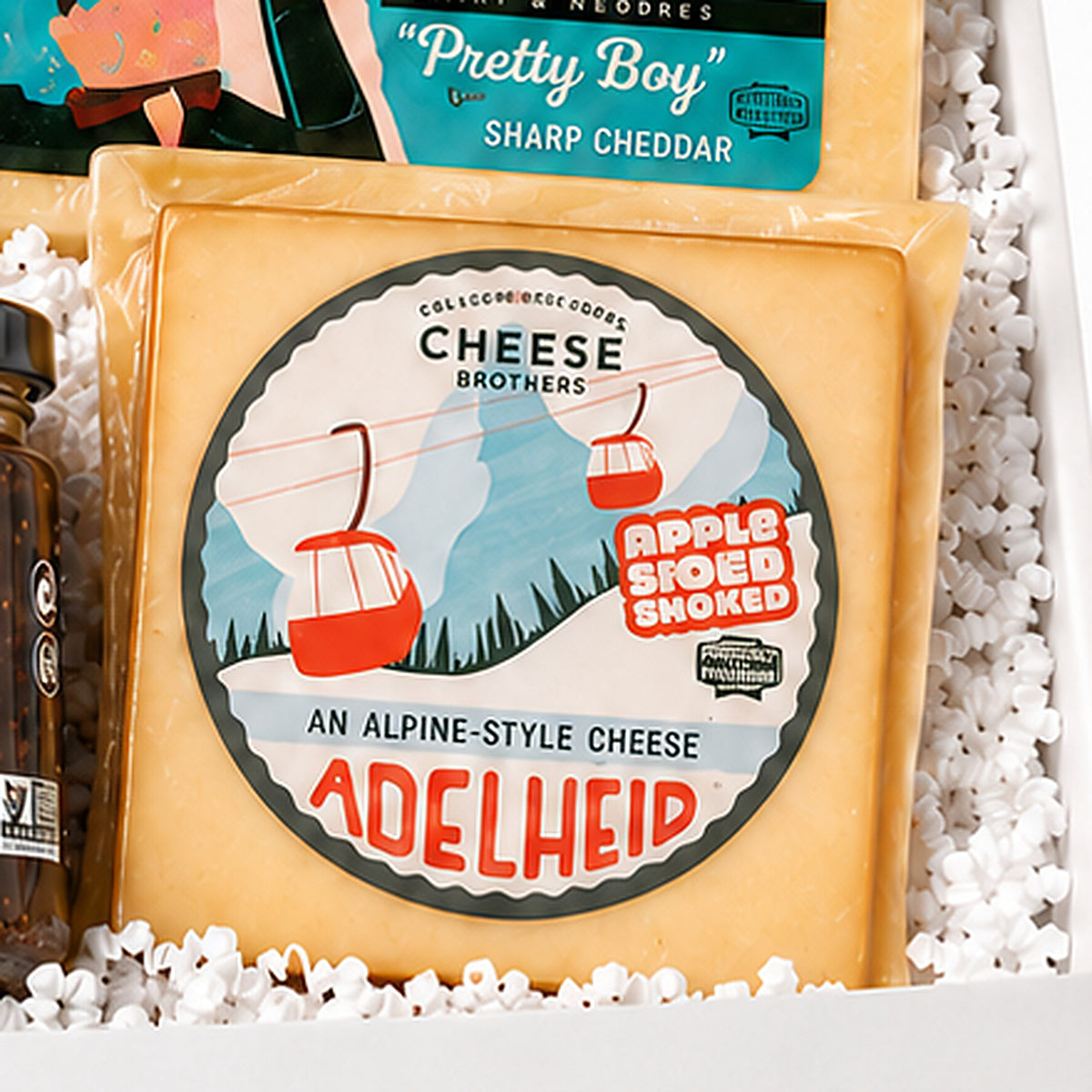 Close-up of the Cheese Brothers cheddar & alpine included in the Charcuterie Gift Box.